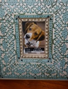 Frame with teal metal overlay